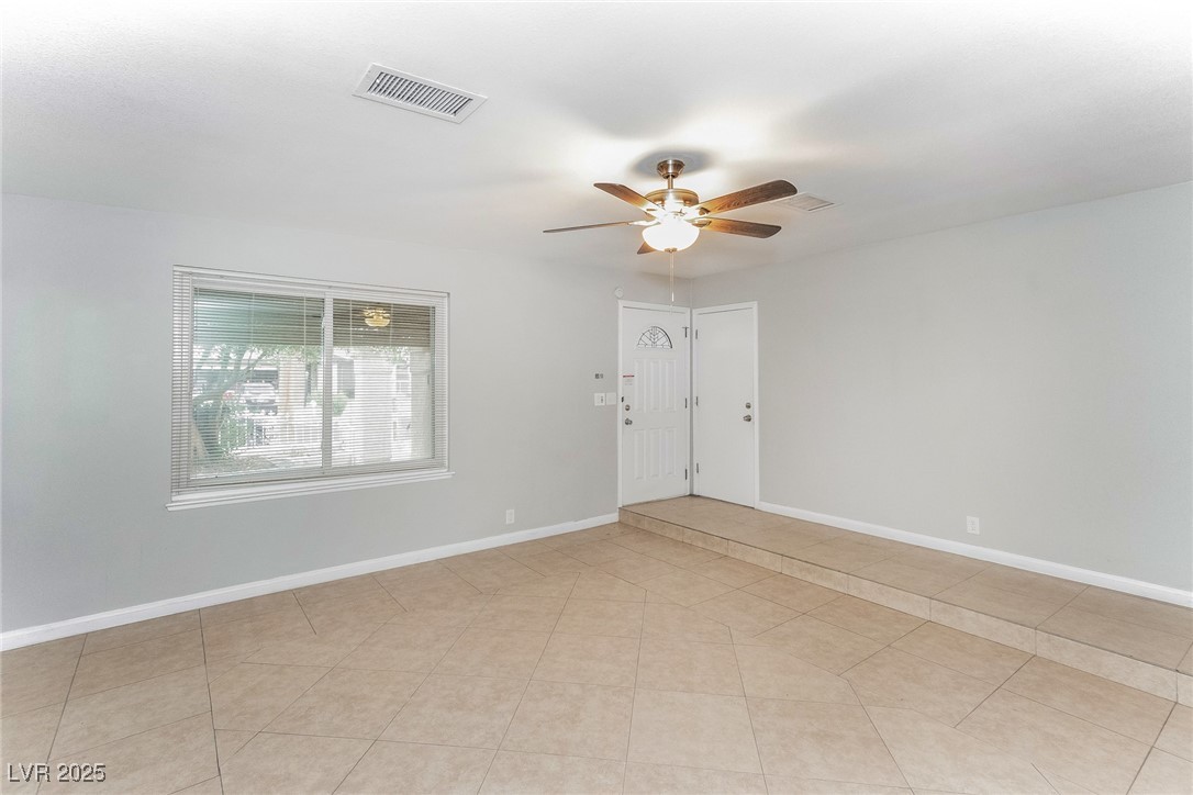 4737 Monaco Road Las Vegas, NV 89121 - Photo 5 of 21 Spare room featuring ceiling fan and light tile pa