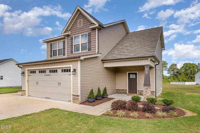 a front view of a house with garden