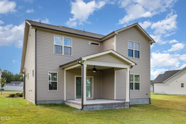 a front view of house with a garden