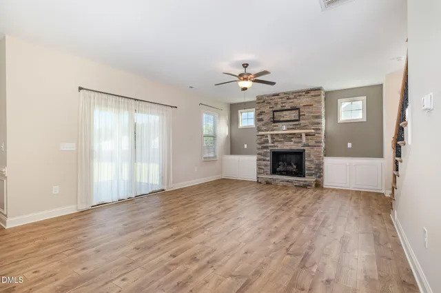 an empty room with a fireplace and window
