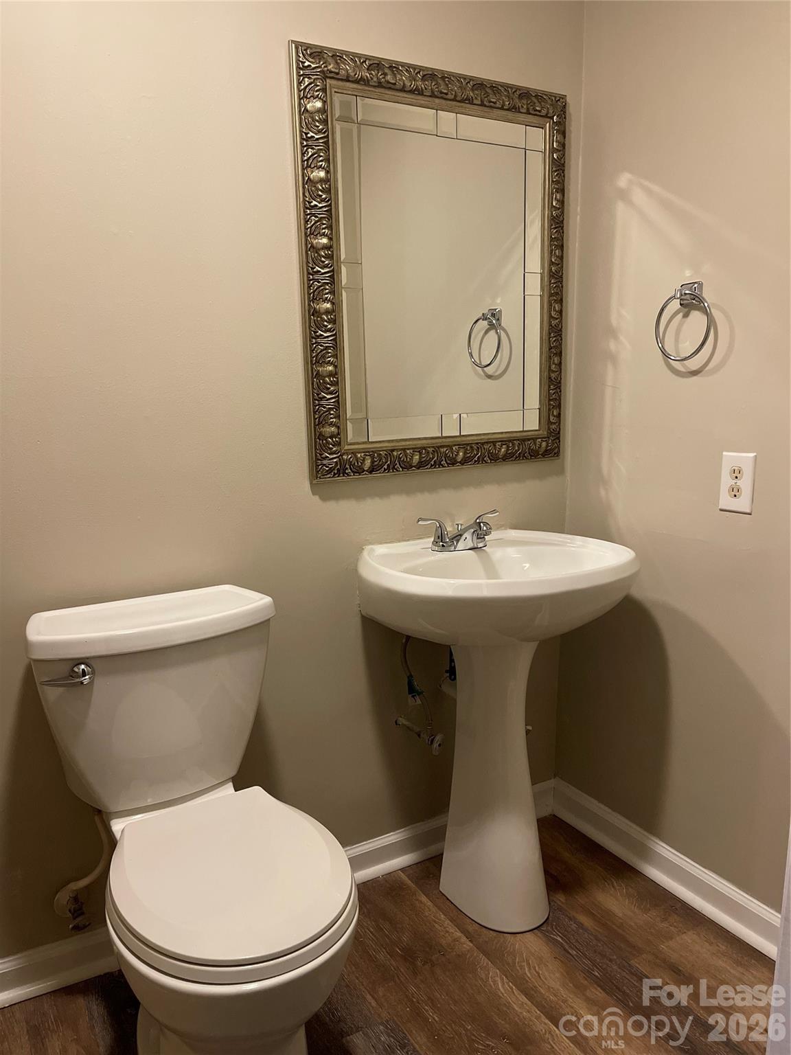 8434 Killian Ridge Court Charlotte, NC 28227 - Photo 15 of 18 a bathroom with a toilet sink and mirror