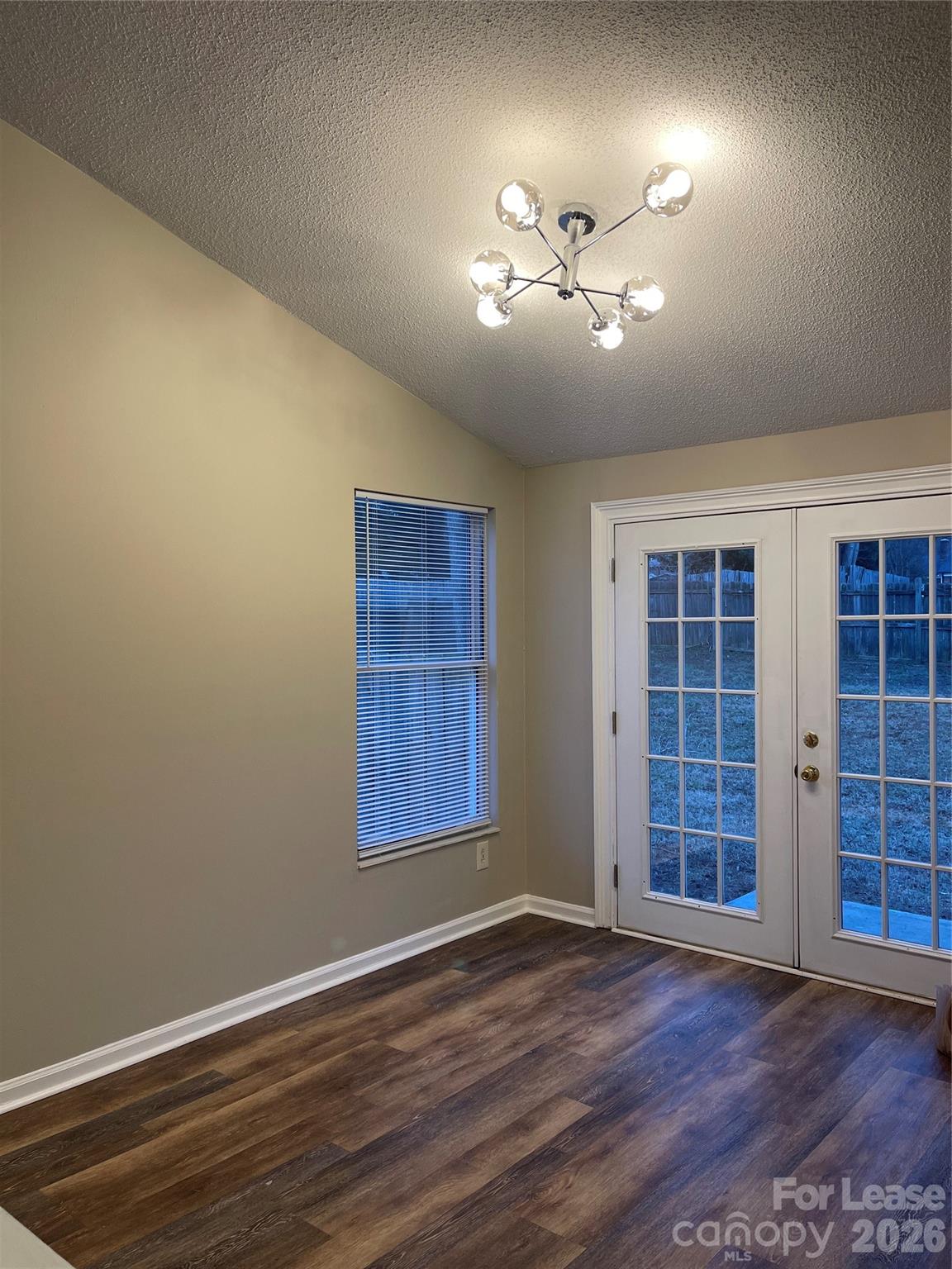 8434 Killian Ridge Court Charlotte, NC 28227 - Photo 7 of 18 a view of an empty room with a window and wooden floor
