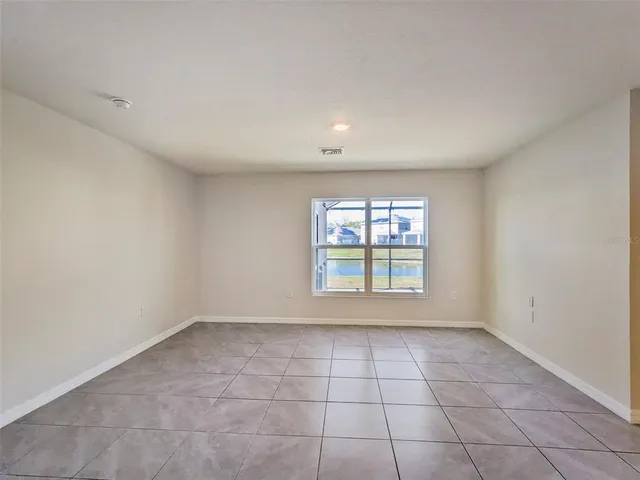 a view of a patio with table and chairs with wooden floor and fence