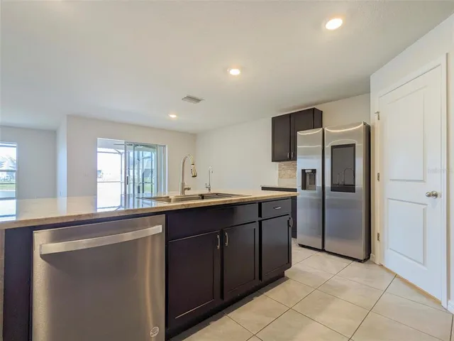 a front view of a house with a garden and plants