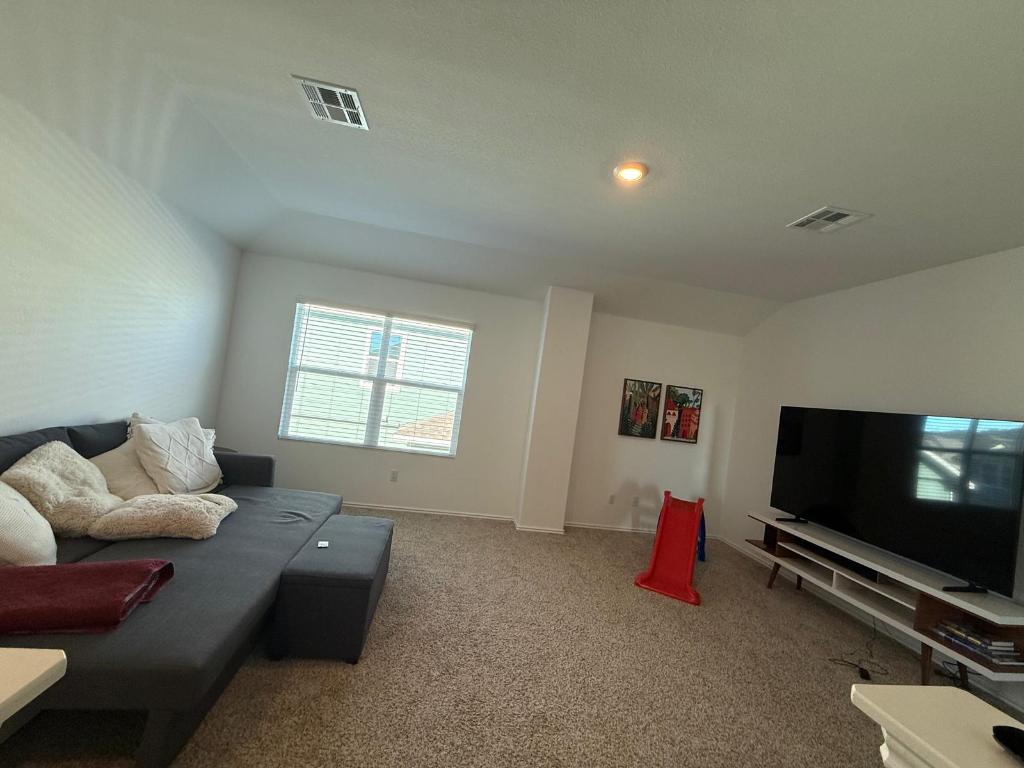380 Mendoza Kyle, TX 78640 - Photo 14 of 28 a living room with furniture and a flat screen tv