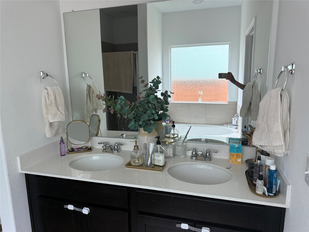 380 Mendoza Kyle, TX 78640 - Photo 19 of 28 a bathroom with a sink and a mirror