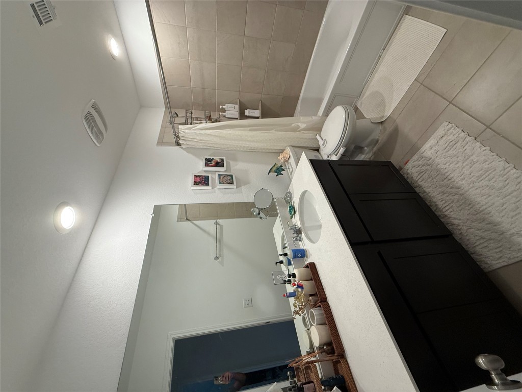 380 Mendoza Kyle, TX 78640 - Photo 24 of 28 a bathroom with a double vanity sink toilet and shower