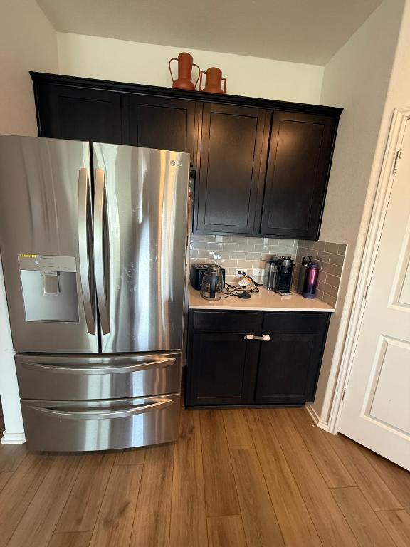 380 Mendoza Kyle, TX 78640 - Photo 6 of 28 a kitchen with stainless steel appliances granite countertop a refrigerator and a wooden floors