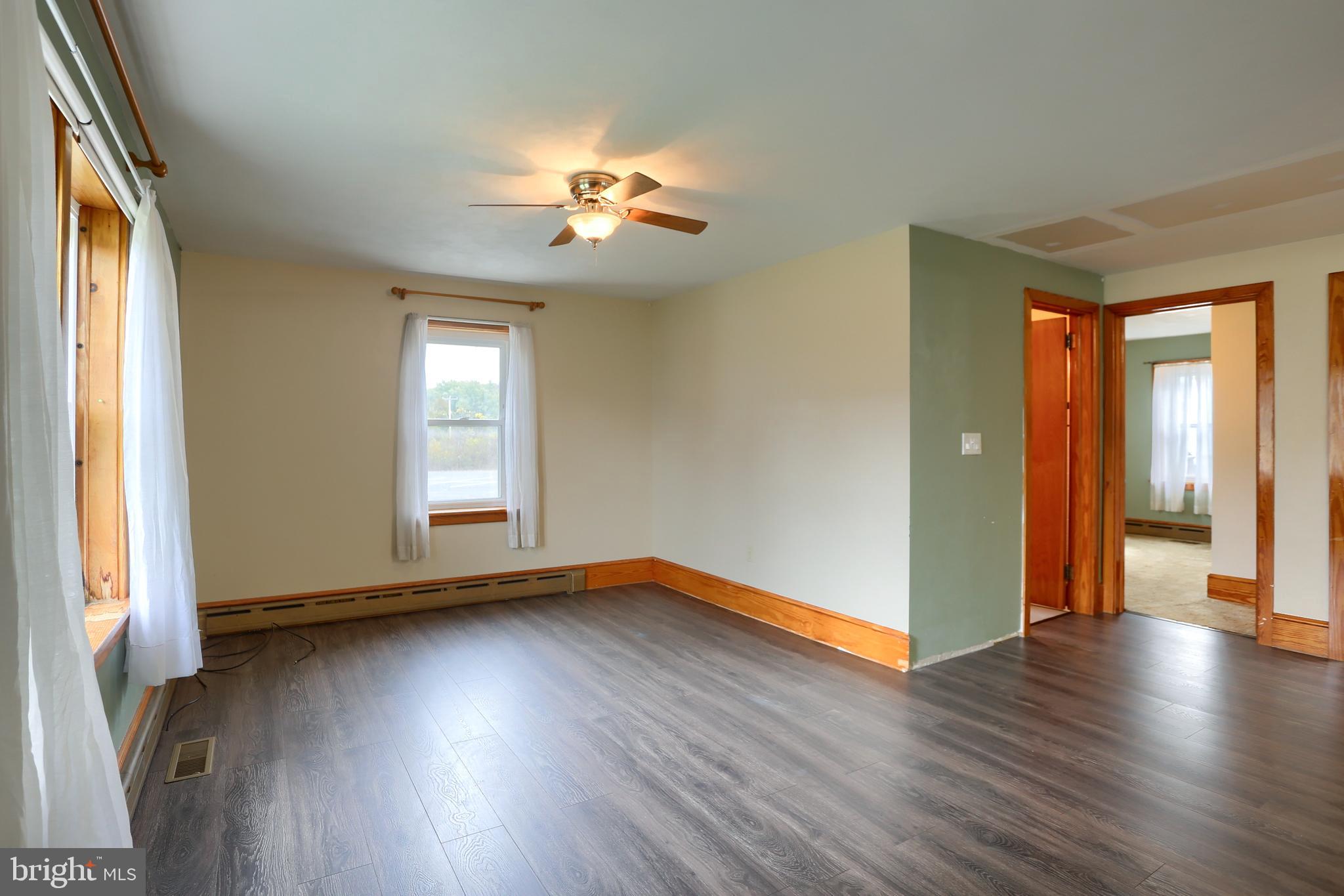 858 Main Street Richfield, PA 17086 - Photo 14 of 29 a view of an empty room with wooden floor and a window