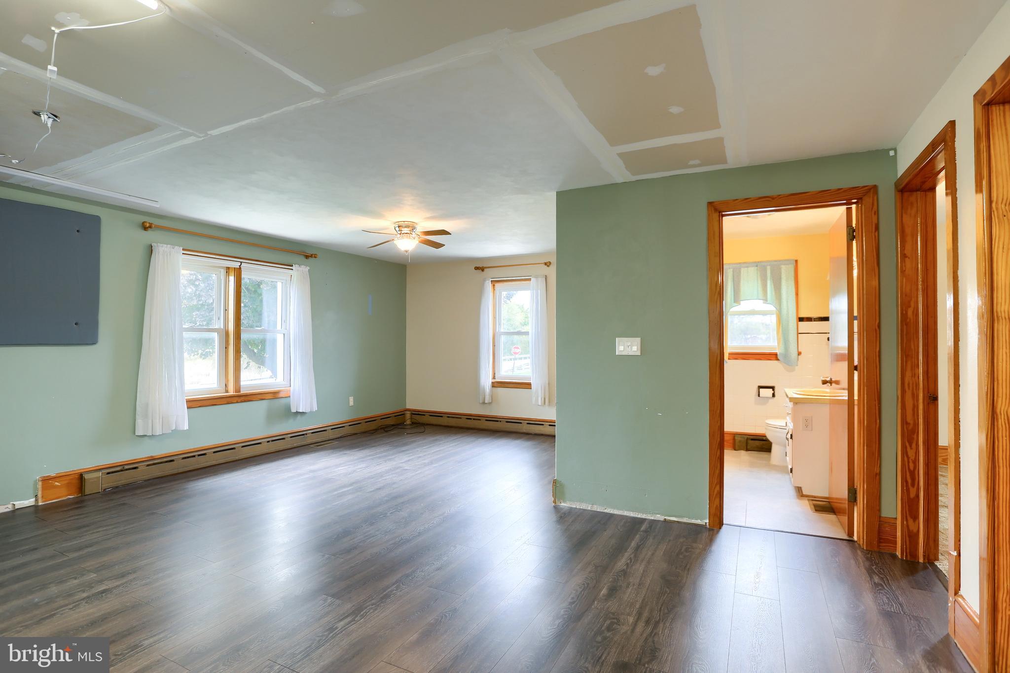 858 Main Street Richfield, PA 17086 - Photo 15 of 29 an empty room with wooden floor and windows