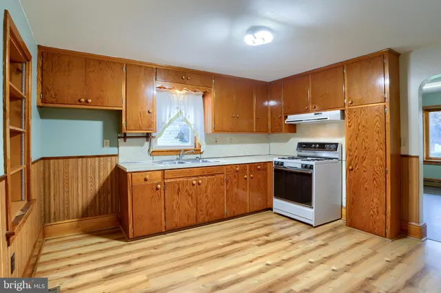 a kitchen with stainless steel appliances granite countertop a refrigerator sink and cabinets