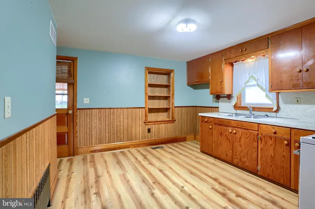 a kitchen with stainless steel appliances granite countertop a sink stove and cabinets