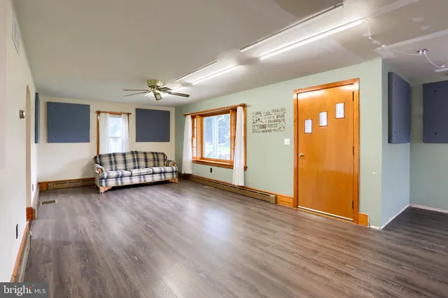 a view of a room with wooden floor and window