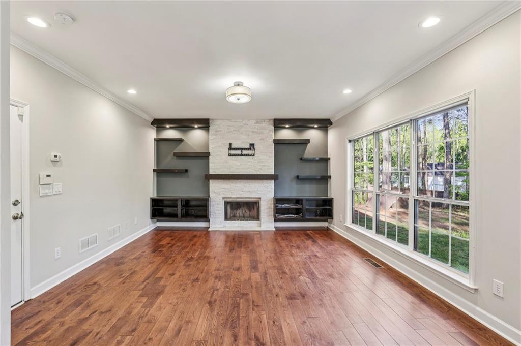 615 Tammany Pointe Alpharetta, GA 30004 - Photo 2 of 15 a living room with furniture a fireplace and wooden floor