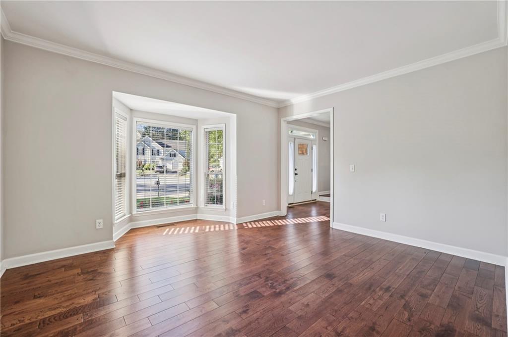615 Tammany Pointe Alpharetta, GA 30004 - Photo 3 of 15 a view of an empty room with wooden floor and a window