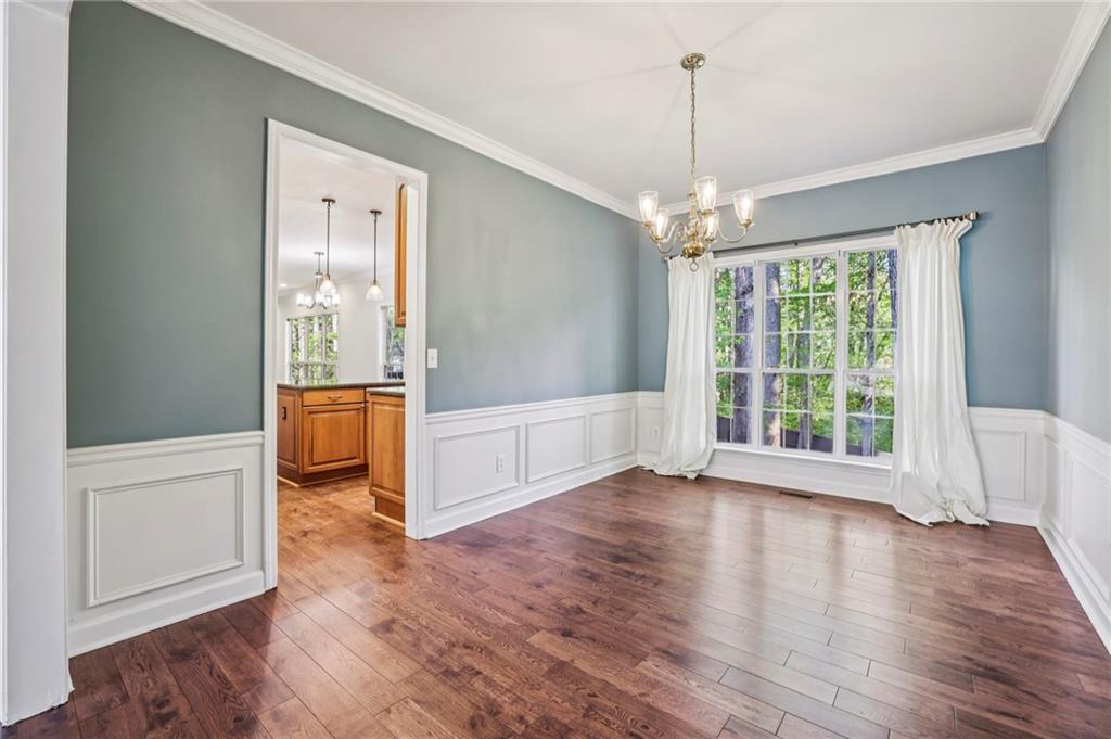 615 Tammany Pointe Alpharetta, GA 30004 - Photo 4 of 15 a view of a room with wooden floor large windows and a chandelier