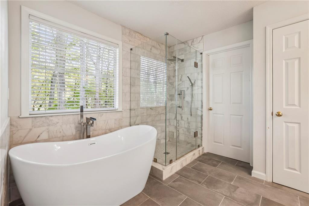 615 Tammany Pointe Alpharetta, GA 30004 - Photo 7 of 15 a white bath tub sitting in a bathroom next to a window