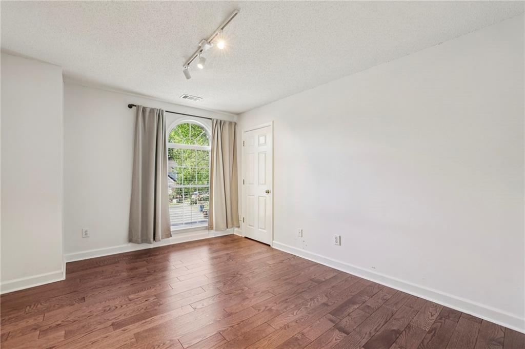 615 Tammany Pointe Alpharetta, GA 30004 - Photo 8 of 15 an empty room with wooden floor and windows