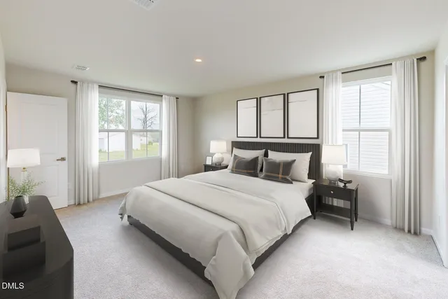 a living room with furniture white walls and wooden floor