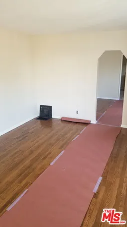 a view of an empty room and wooden floor