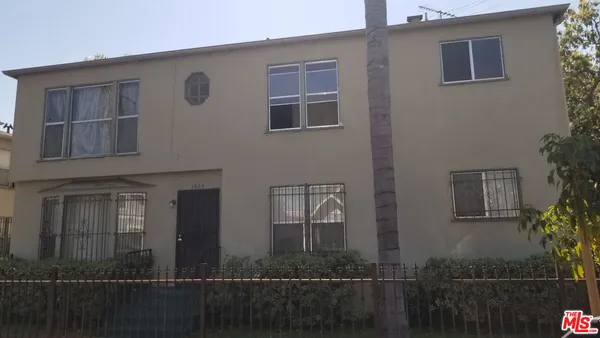 a front view of a house with plants