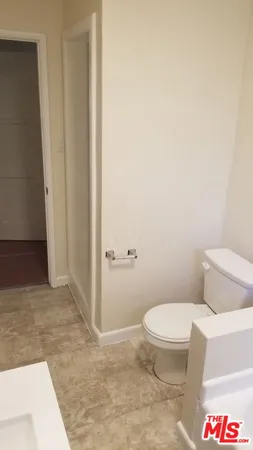 a white toilet sitting next to a sink
