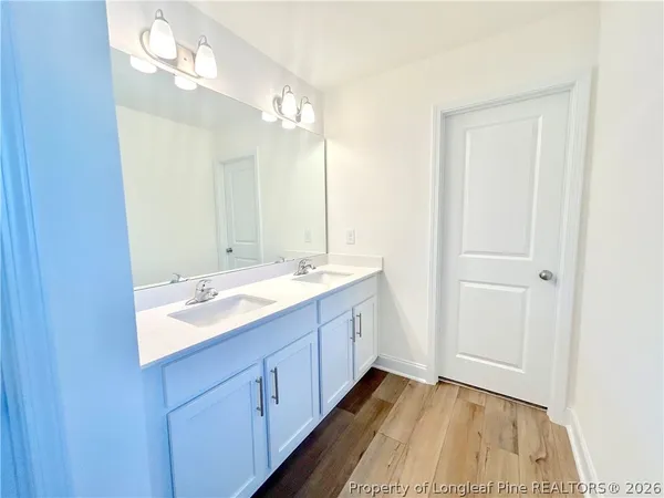 a bathroom with a double vanity sink and mirror