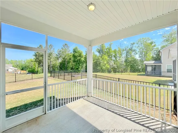 a view of a balcony with floor to ceiling windows with wooden floor