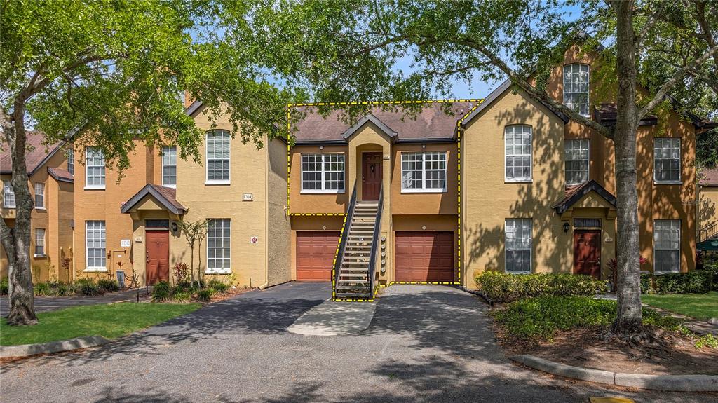 6364 Raleigh Street, Unit 1615 Orlando, FL 32835 - Photo 1 of 1 a front view of a house with a yard