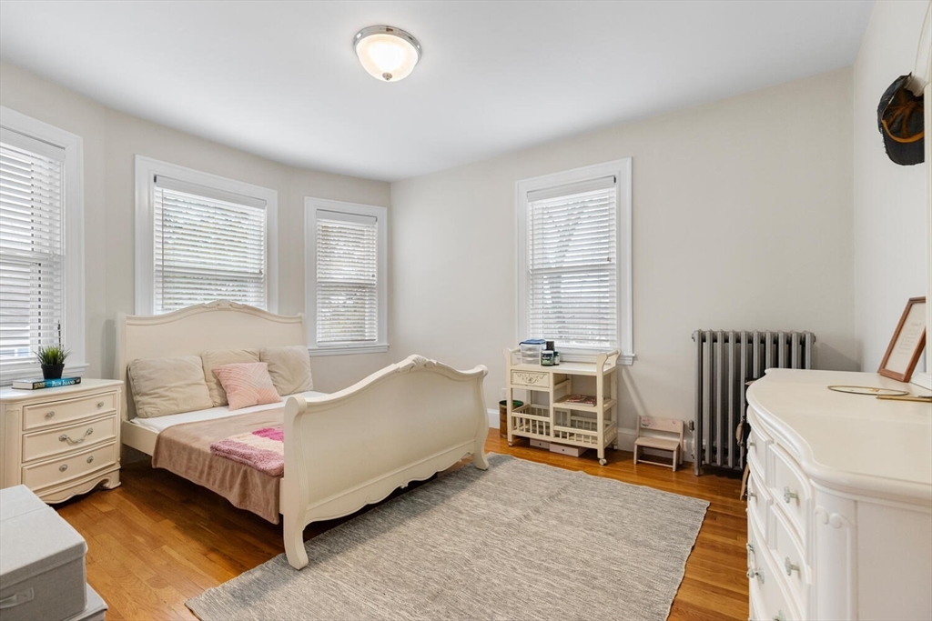 35 Richardson Street, Unit 2 Wakefield, MA 01880 - Photo 19 of 32 a bed room with a bed and a chair