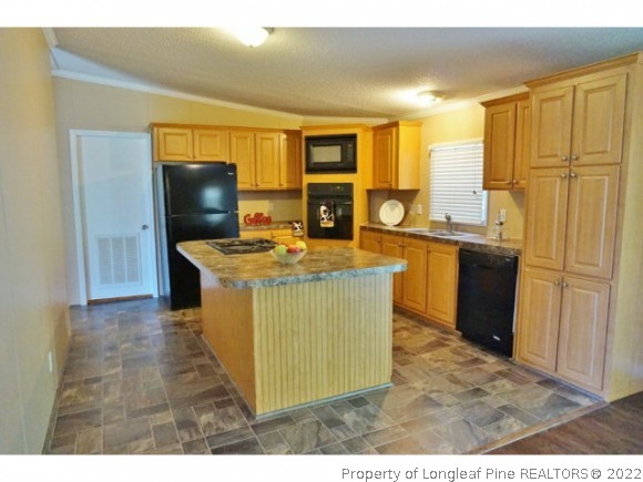 2972 Underwood Road Carthage, NC 28327 - Photo 5 of 24 a kitchen with stainless steel appliances granite countertop a stove a sink and a refrigerator