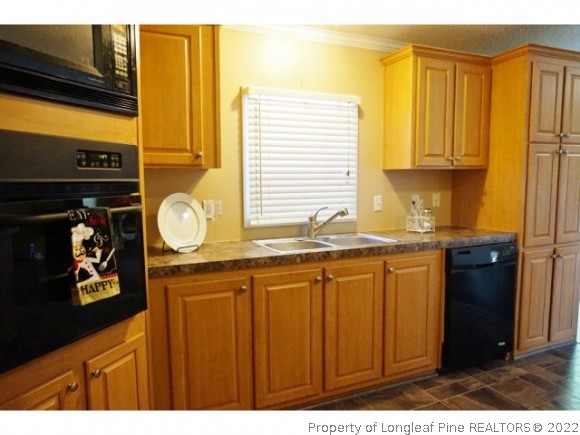 2972 Underwood Road Carthage, NC 28327 - Photo 8 of 24 a kitchen with granite countertop a sink and cabinets