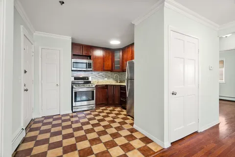 a kitchen with stainless steel appliances granite countertop a refrigerator and a stove top oven