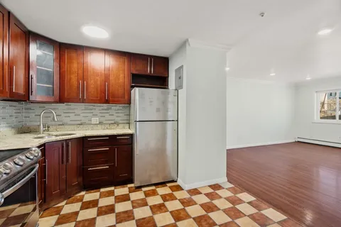 a kitchen with a refrigerator and a sink