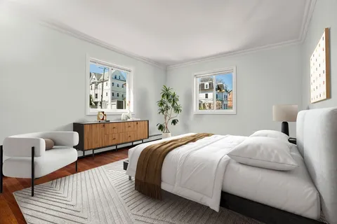 a bedroom with two beds and a window