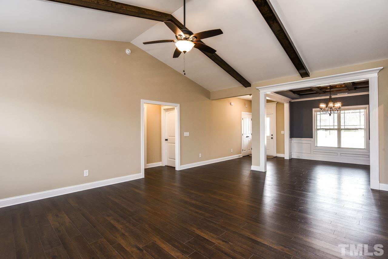 43 Sharpstone Lane Clayton, NC 27527 - Photo 11 of 39 a view of an empty room with a window and wooden floor