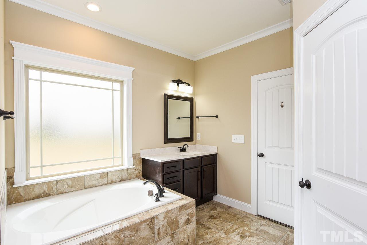 43 Sharpstone Lane Clayton, NC 27527 - Photo 16 of 39 a bathroom with a sink and a bathtub