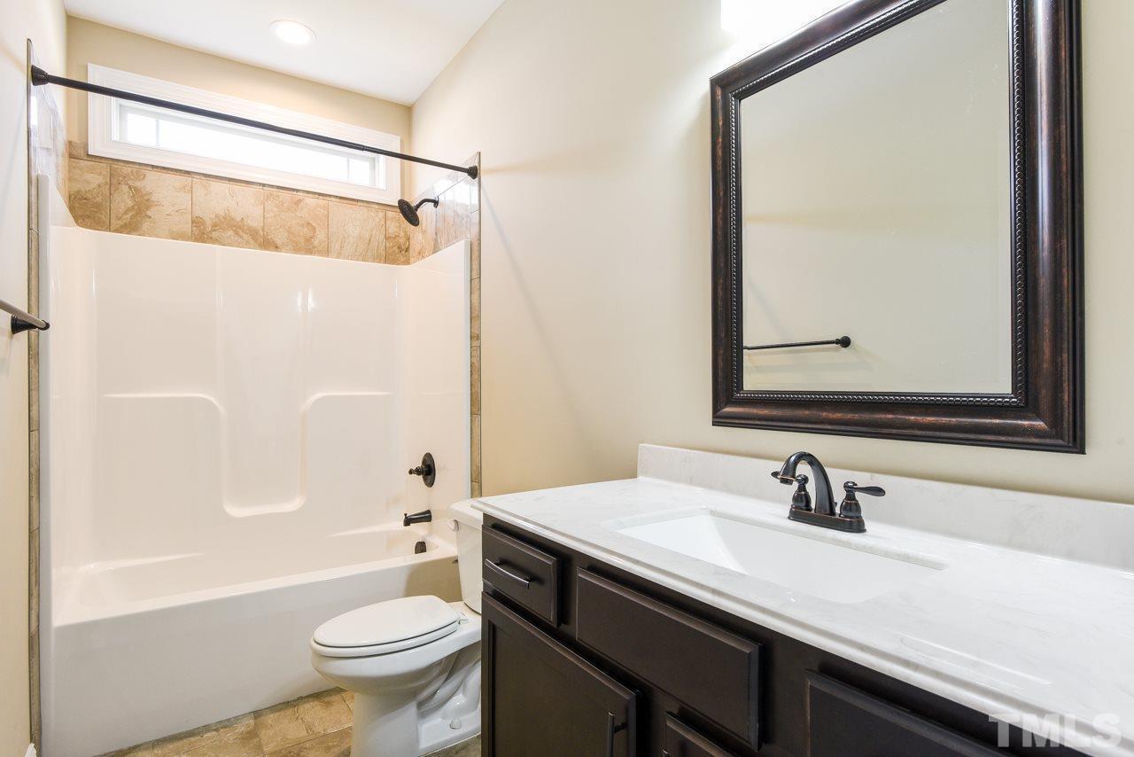 43 Sharpstone Lane Clayton, NC 27527 - Photo 17 of 39 a bathroom with a sink and a mirror