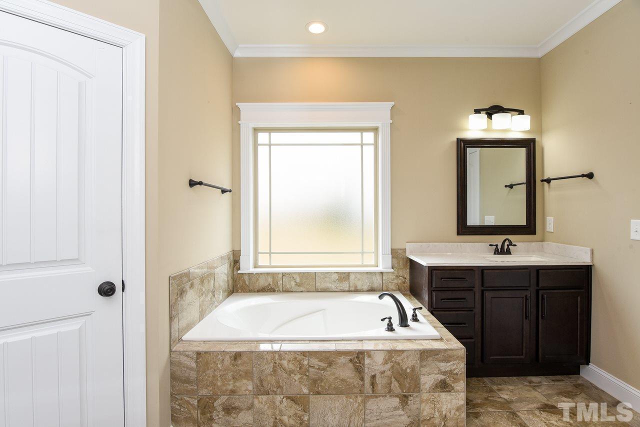 43 Sharpstone Lane Clayton, NC 27527 - Photo 21 of 39 a bath tub sitting in a bathroom next to a sink