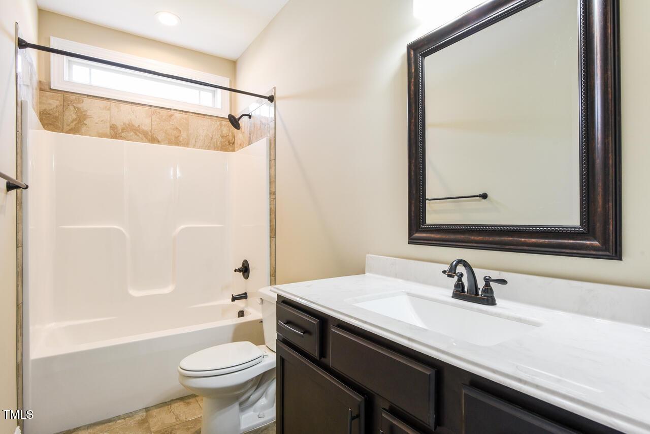 43 Sharpstone Lane Clayton, NC 27527 - Photo 30 of 39 a bathroom with a sink and a mirror