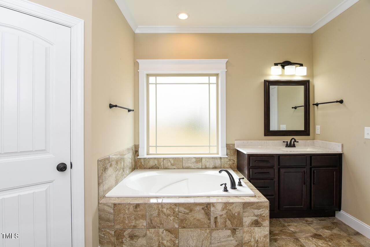 43 Sharpstone Lane Clayton, NC 27527 - Photo 32 of 39 a bath tub sitting in a bathroom next to a sink