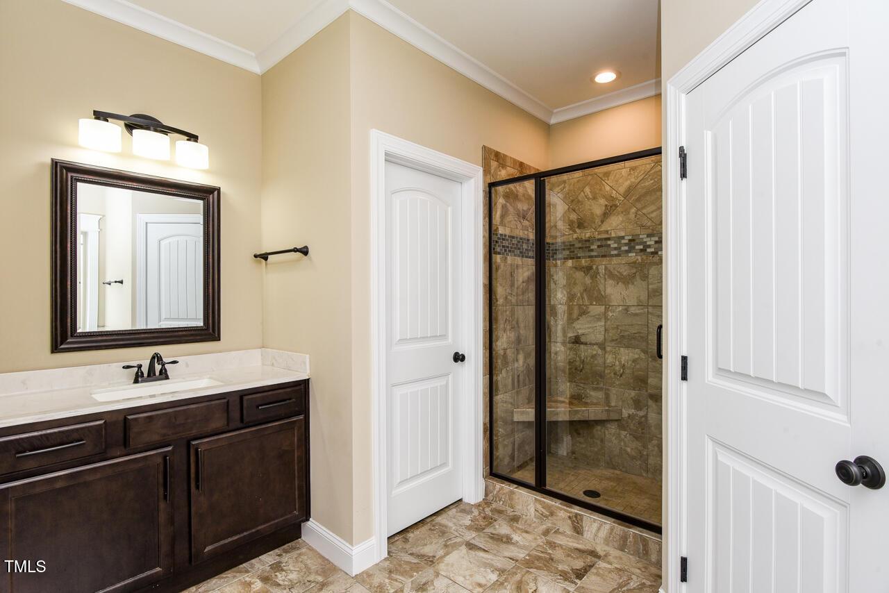 43 Sharpstone Lane Clayton, NC 27527 - Photo 35 of 39 a bathroom with a double vanity sink mirror and shower