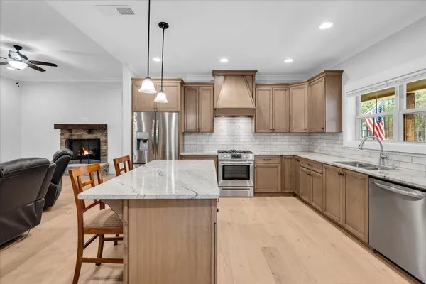 a stove top oven sitting inside of a kitchen