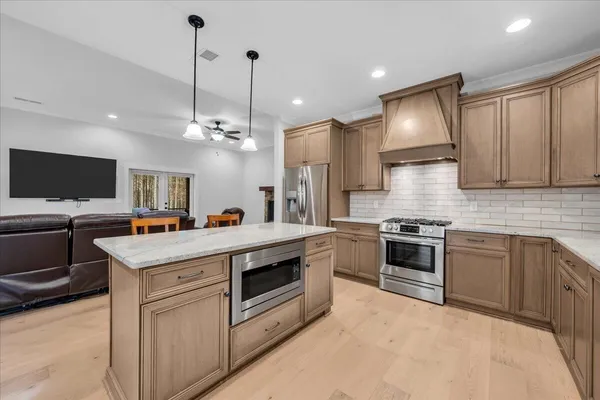 a kitchen with granite countertop a sink and a window