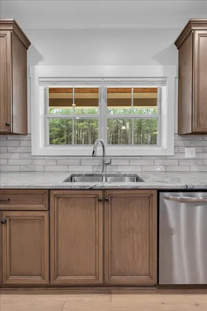 a bathroom with a granite countertop sink mirror and double