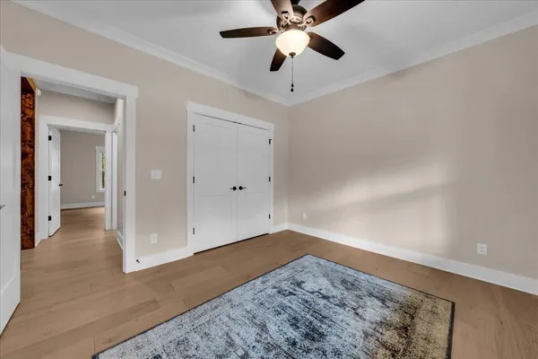 a view of empty room with wooden floor