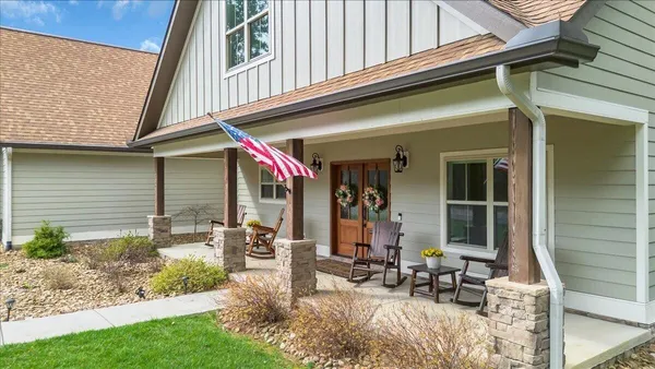 a front view of a house with garden and porch