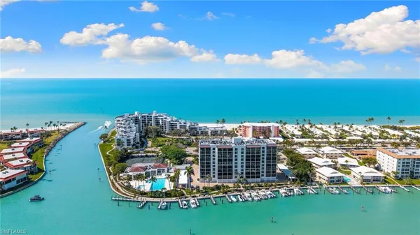 a view of a city with lots of residential buildings ocean and mountain view in back