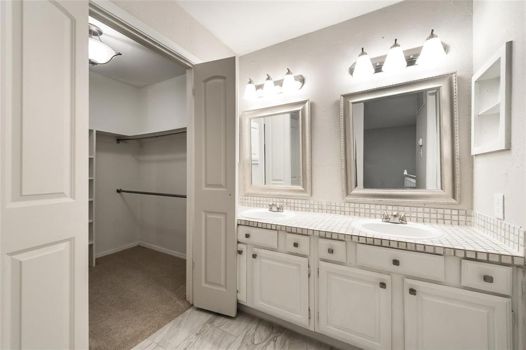 18240 Midway Road, Unit 302 Dallas, TX 75287 - Photo 21 of 33 a bathroom with a sink and mirror