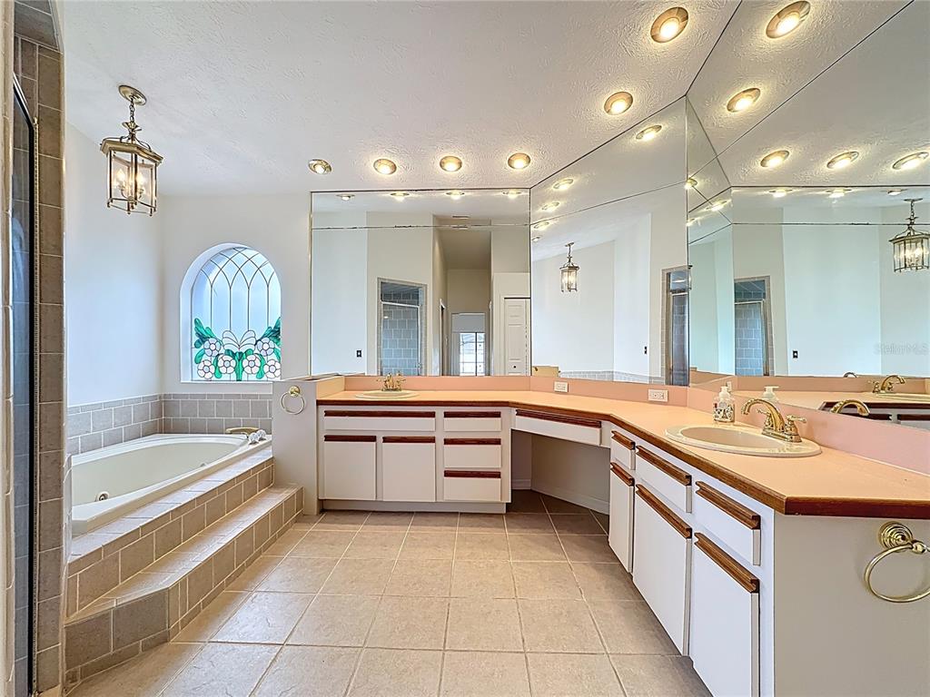 2414 Buckhorn Run Drive Valrico, FL 33596 - Photo 12 of 50 a large white bathroom with a large tub sink and double vanity